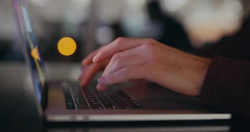 Male Hands Typing Text on Laptop Keyboard