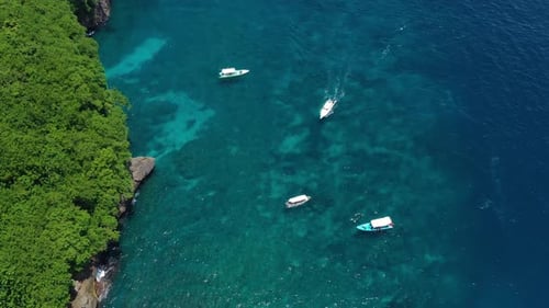 Coast and fishing boat as a background from top view. Turquoise water background from top drone.