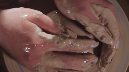 Hands Shaping Clay on a Spinning Pottery Wheel