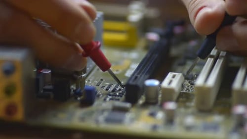 Professional Man Is Repairing Electronic Chip at Table in Modern Service Center. Irrl