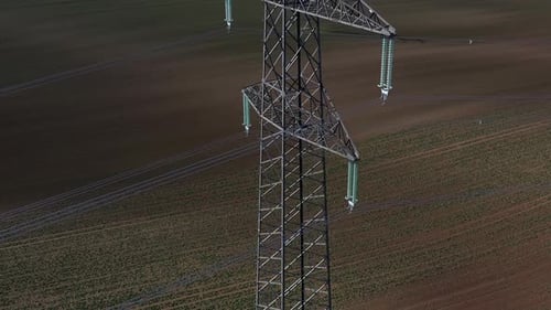 Aerial View of Electricity Pylon in a Farm Field
