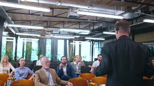 Speaker Presents to Diverse Audience in Conference Room