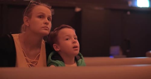 Mom and kid spending leisure at the cinema
