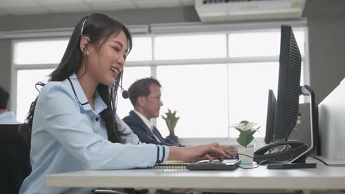 Call center young employee working with headset