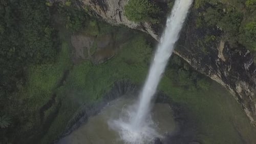 Aerial View of Tropical Waterfall and Lush Greenery