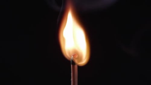 Match slowly being lit by blue laser pointer