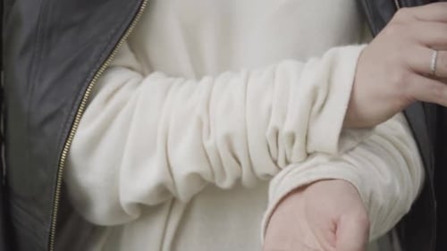 Closeup of Woman Disinfecting Hands with Sanitizer Outdoors