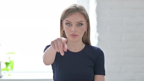Smiling Woman Points Directly At the Camera