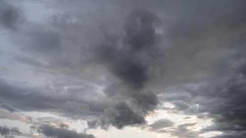 Dramatic Rain Clouds Moving Across Sunset Sky