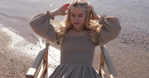 Gorgeous slim mixed race Asian Caucasian woman in a dress, spending holidays on the sea shore.