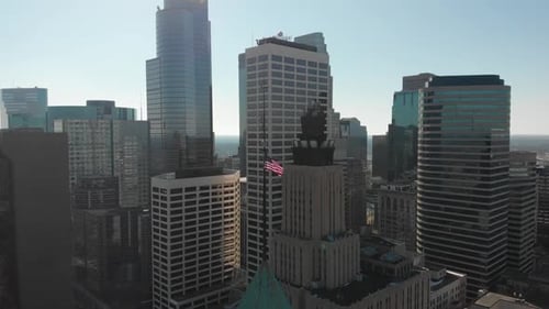Aerial View of City Skyline with Flag