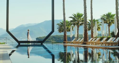 Young lady standing over the pool on holidays. Travel vacation woman relaxing