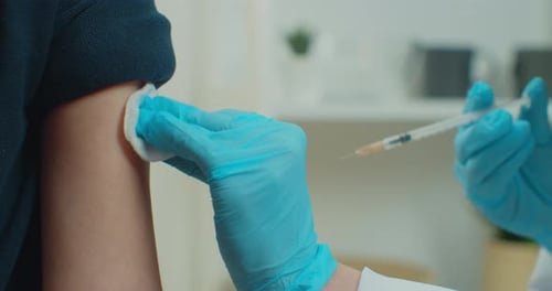 Close Up of Little Child Patient Sitting in Mask at Home During Coronavirus While Professional