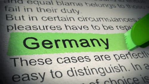 Germany. Highlighter pen marks word in Newspaper. Closeup. Thumbing pages and promoting text with ma