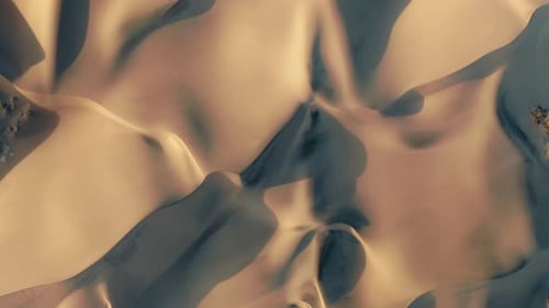 Aerial View of a Drone Flying Over Beautiful Massive Golden Sand Dunes on Sunset