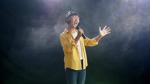 Teen Singing into Microphone Wearing Headphones