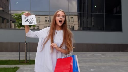 Teen Girl Showing Up To 50 Percent Off Inscription, Advertising Discounts, Shopping on Black Friday