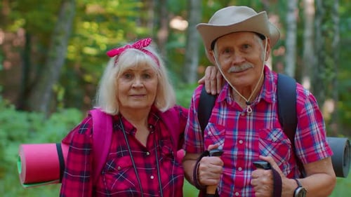 Happy Senior Couple Hiking Together in a Forest