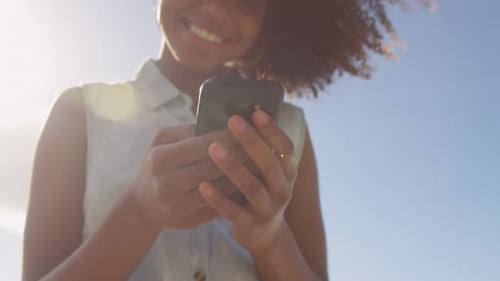 Woman using mobile phone in the beach 4k