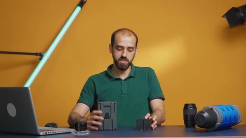 Man Presents Camera and Tech Equipment in Studio