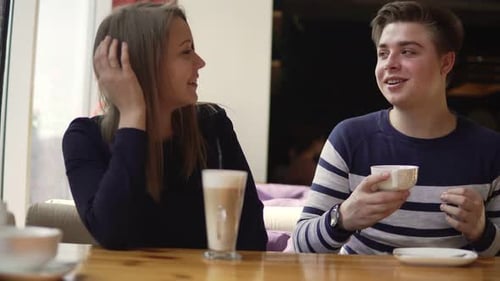 Young Couple Sittin in Cafe