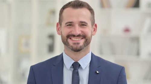 Smiling Businessman Wearing a Suit and Tie