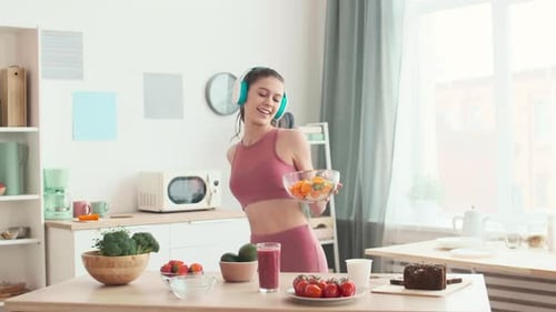 Happy Woman Dancing, Preparing a Salad, and Smoothie
