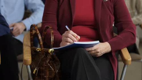 Business Meeting Attendees Taking Notes Indoors