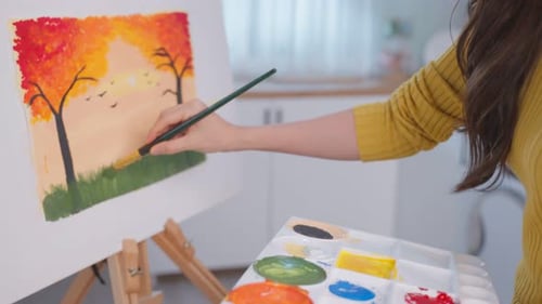 Young Woman Painting a Landscape on Canvas