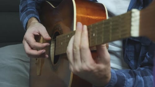Person Plays Acoustic Guitar
