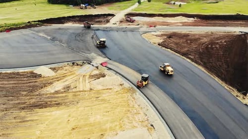 Aerial View of the Yellow Road Rollers That Lay the Asphalt of the Test Ground for Cars