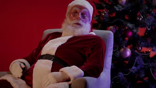 Santa Claus Wakes Up Next To Christmas Tree
