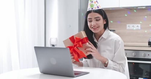 Woman Celebrates Birthday with Video Call and Gift