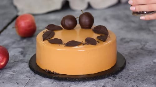 Pastry Chef Decorating the Mousse Cake with Small Chocolate Pieces. Pastry Chef Decorated Modern