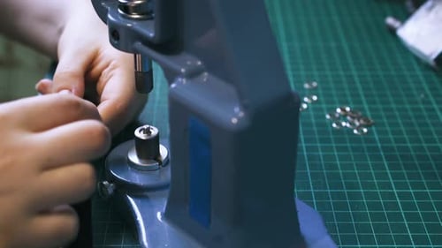 Attaching Metal Eyelets to Strap with Machine Close Up