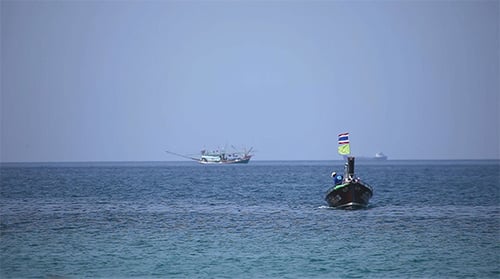 Longtail Boat on Turquoise Ocean with Thai Flag