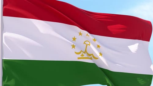 Realistic Waving Flag of Tajikistan against Blue Sky