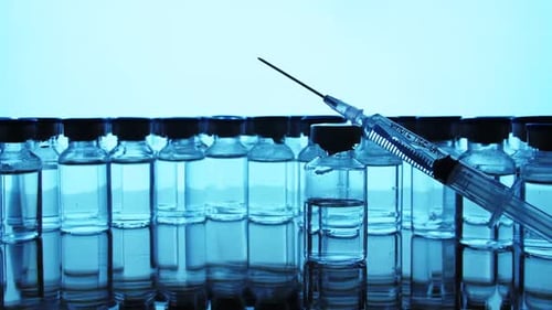 Vials and Syringe Representing Medical Science