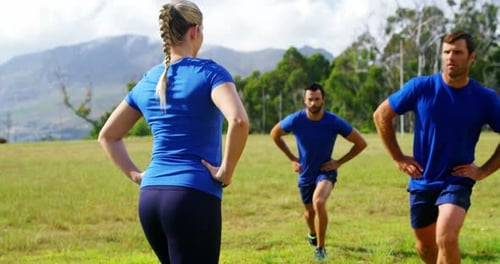 Female trainer training people in boot camp