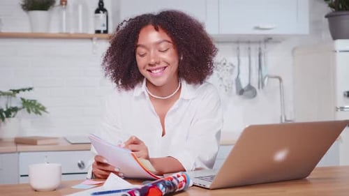 Woman Talking to Laptop in Bright Kitchen