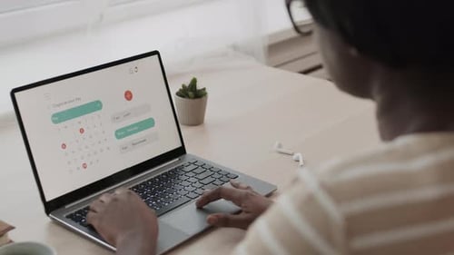 Woman Using Laptop to Plan Her Day
