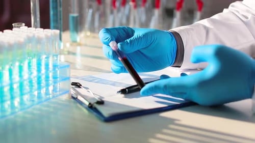 Scientist Adding Vial to Test Tube Rack