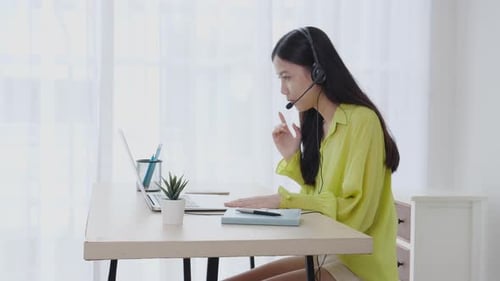 Woman with Headset Working at Home Office