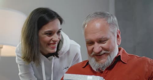 Family Birthday Celebration with Gift and Affectionate Hug