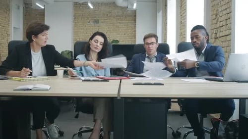 Wide Shot of Multiracial Business Partners Signing Documents in Office. Serious Confident Caucasian