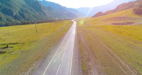 Flight Over Mountain Asphalt Highway Road and Meadow