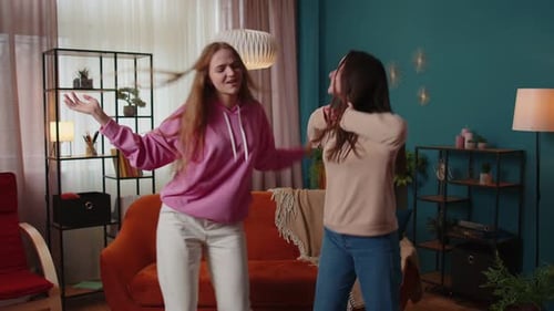 Two Young Women Dancing Together at Home