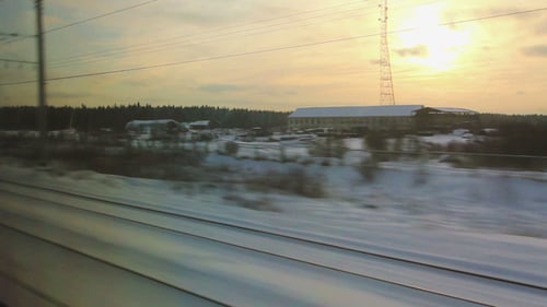 Train Window View of Snowy Rural Sunrise