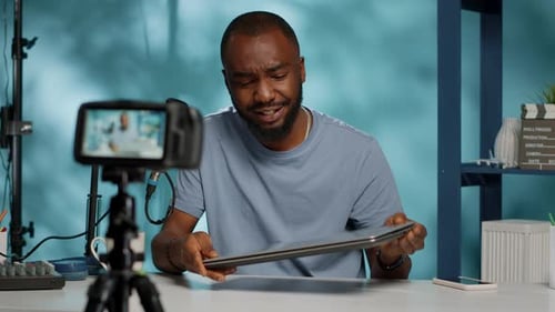 Close Up of Vlogger Reviewing Modern Laptop on Camera