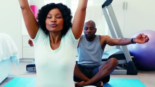 Couple performing yoga